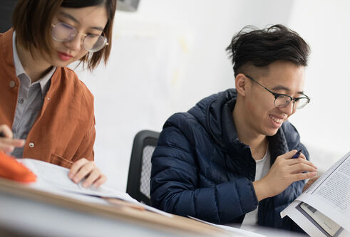 two students studying at a desk