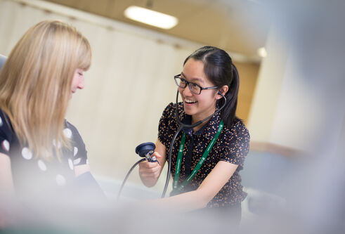 Student taking blood pressure