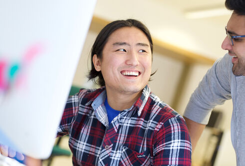 Man smiling at computer