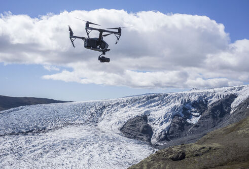 Photograph of a drone in flight above Skálafellsjökull glacier