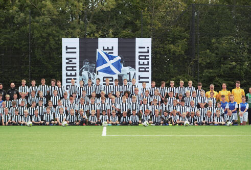 A large group of children in football strips