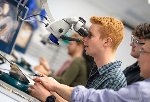 Student looking into a microscope