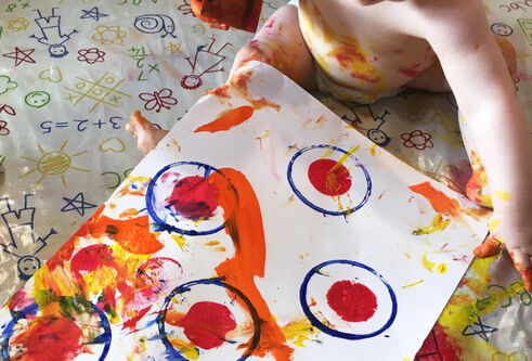 Baby playing with paints