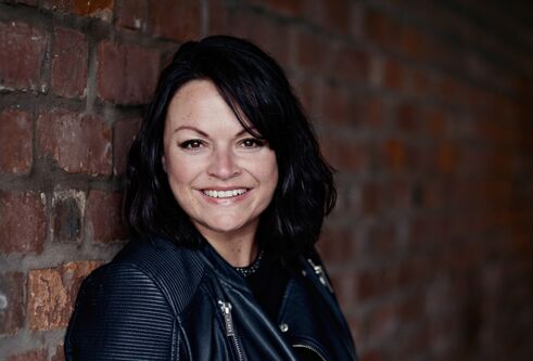 Caroline McKenna standing by a wall