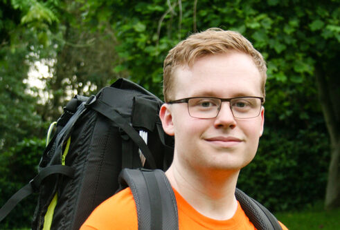 Student Curtis Large wearing a hiking backpack