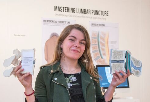 Renske Hoste holding models of bones