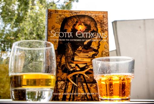 A book on a table with glasses of whisky and irn bru in the foreground
