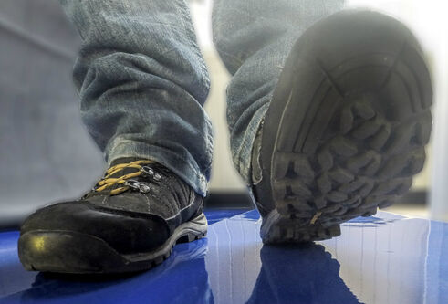 A pair of shoes walking towards a camera