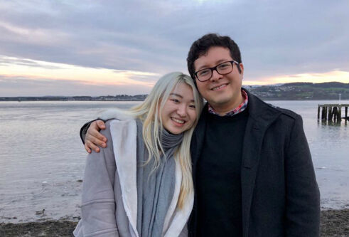A couple hugging in front of the Firth of Tay