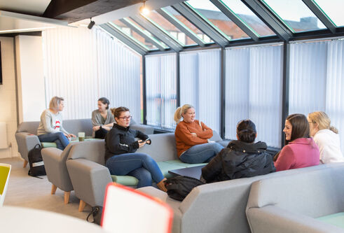 People sitting on grey sofas