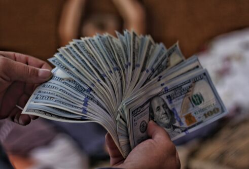 cash notes being held in a hand