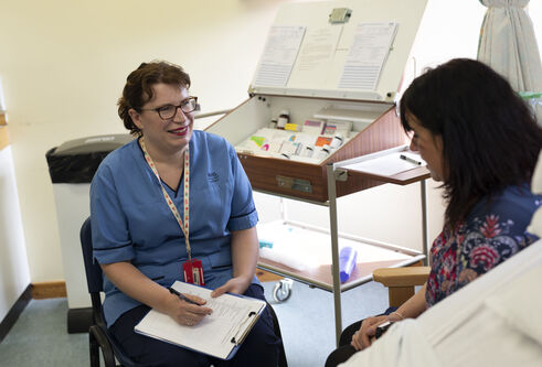 Nursing student in classroom with "patient"