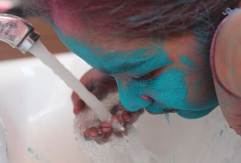Indian girl with blue powder on face for special event