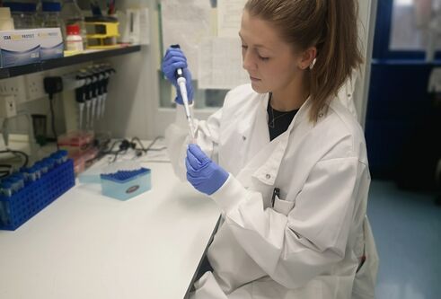Dr Amy Lloyd sitting in her lab