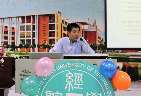 Dr Mu giving a talk at a podium