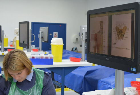 A photograph of a person in uniform working in the Thiel Cadaver Facility
