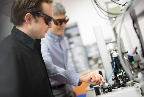 two men using the Applied Laser Technology Laboratory