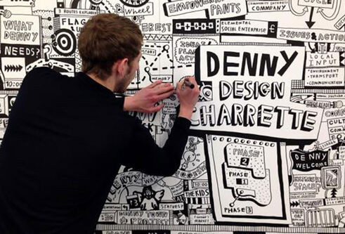Man drawing in black and white on a wall