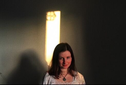 an image of a woman with a dark background behind her