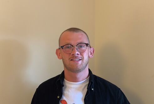 an image of Angus holding an American Express mug