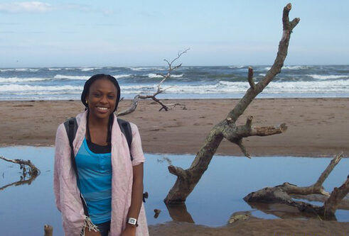 Monica standing on a beach