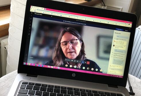 An image of a member of staff on a laptop
