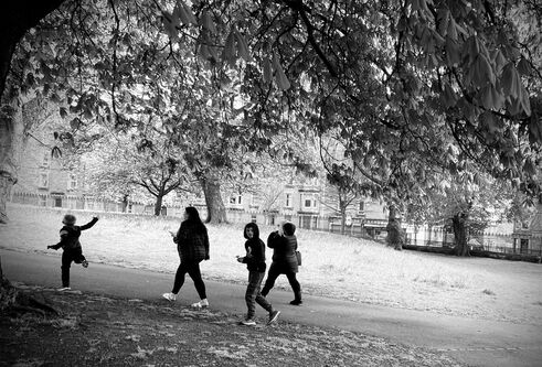 a black and white image of a small group of people walking