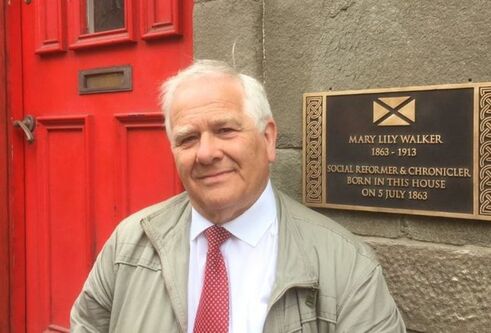Eddie Small standing in front of the door of Mary Lily Walker's house