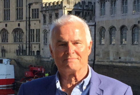 Graeme Martin standing with buildings behind him