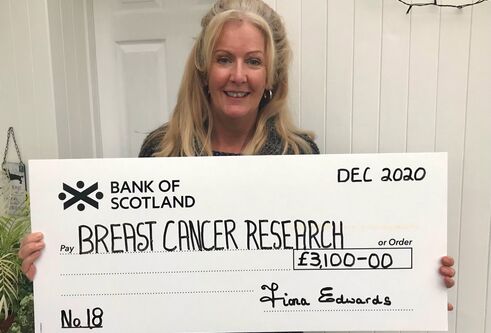 Fiona Edwards with cheque for breast cancer research