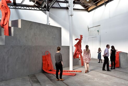 People in exhibition with large red zips