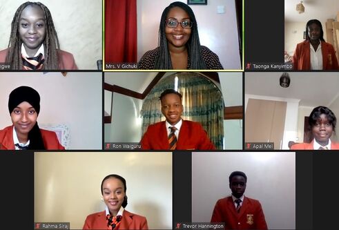 Brookhouse school pupils in red uniform smiling on video call