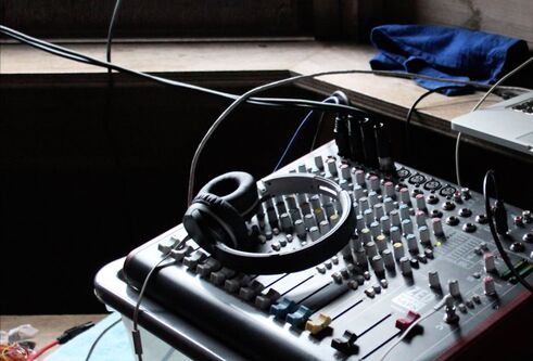 an image of headphones and a sound desk