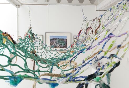 green and blue fishing net strung up on ceiling 