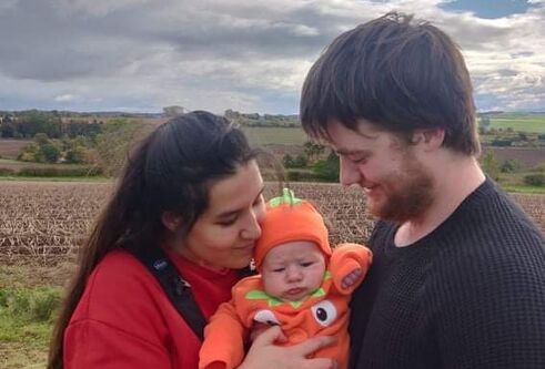 Eshar and Georgie holding Baby Archie
