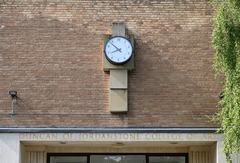 mid shot of clock installation on red brick of Dundee's cooper gallery