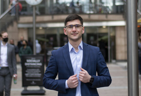 a man in a suit looking at the camera