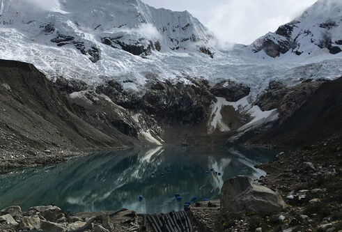 Melting glacier with a lake at the bottom of a valley