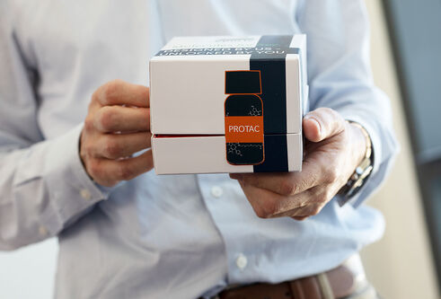 Researcher holding PROTAC box