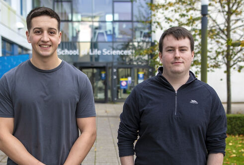 Scientists standing outside the Discovery Centre building