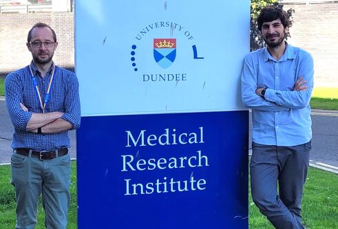 2 men infront of Medical reseach institute sign