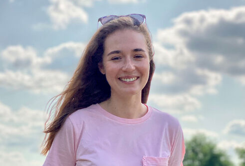 Jasmin Hirn with the sky and clouds behind her