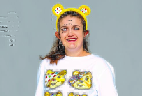 a young girl wearing yellow ears headband and white tshirt with four yellow bears