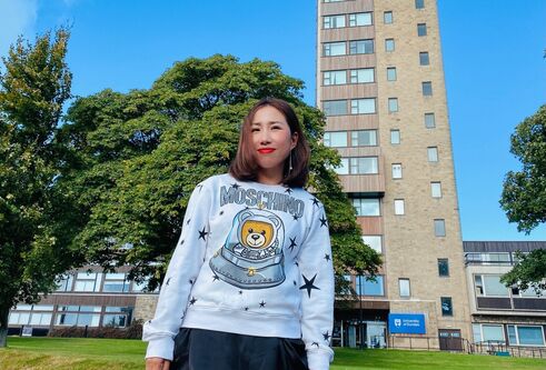 Jing Yang standing at the front of the Tower Building