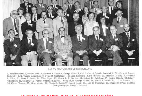 black and white photo showing group of people wearing suits and name badges