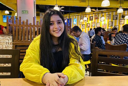 Young Indian student Ananya Bhatt sits in a restaurant