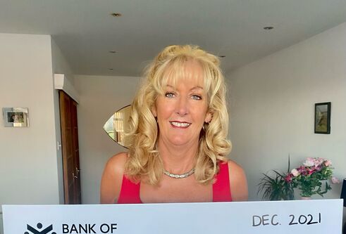 Fundraiser Fiona Edwards holds cheque for £4500 for breast cancer research