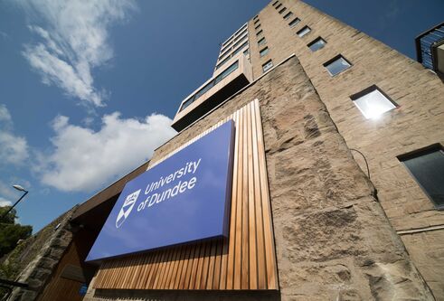 Tower Building with the University of Dundee logo and blue skies above