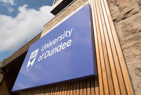 Tower Building with University of Dundee logo and blue skies above