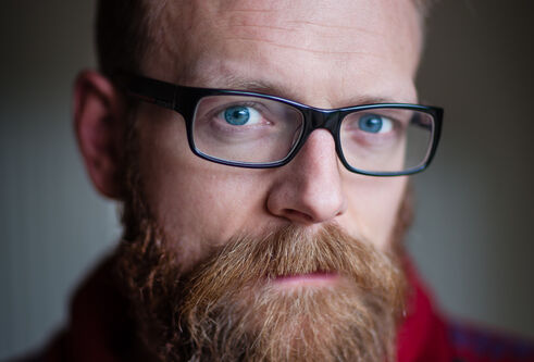 Middle aged man with beard and glasses